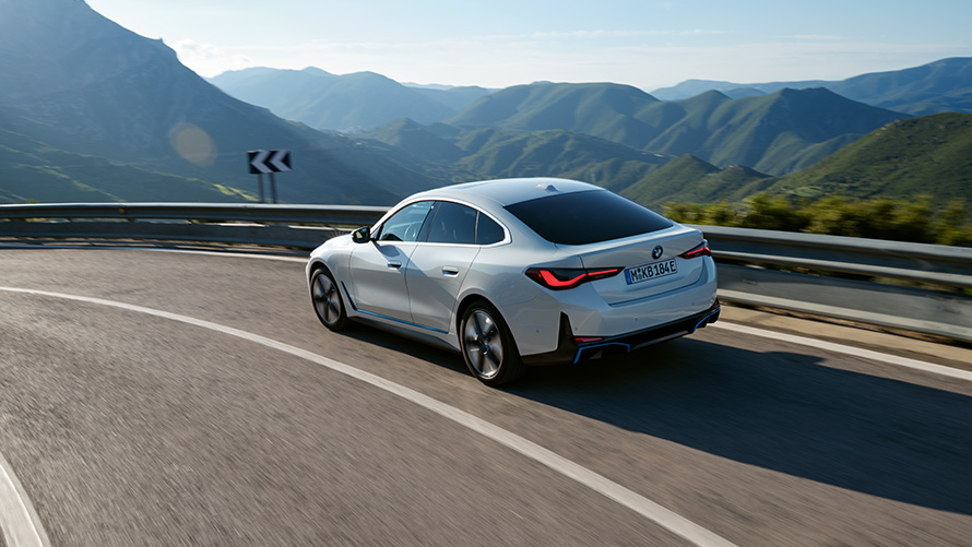 Fleet Data BMW Special Sales Sustainability Hub Overview BMW Special Sales Sustainability Hub Overview Fleet Data BMW vehicle driving on road in front of mountain scenery